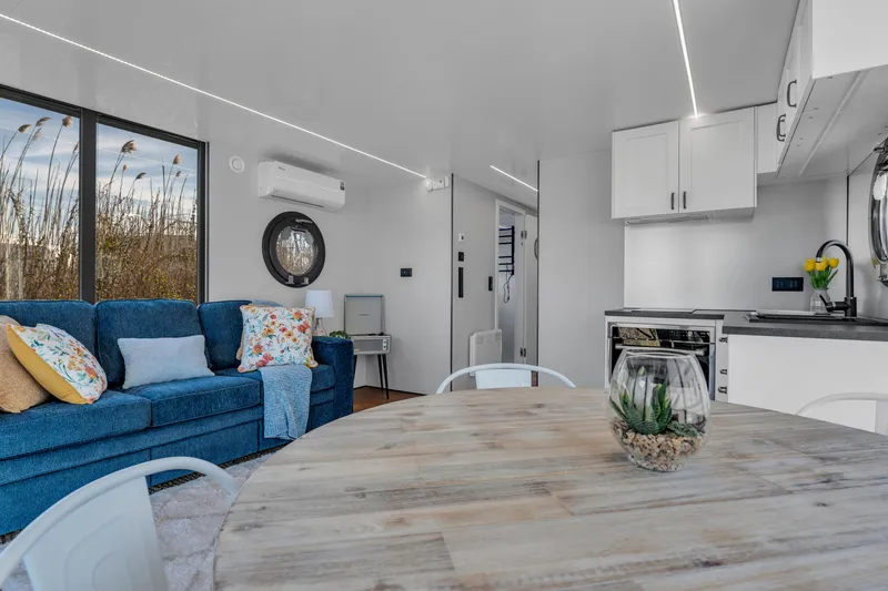 Slide: The Image of Modern interior of 2024 Waterlodge Apart EL with cozy living area and kitchen. - 21