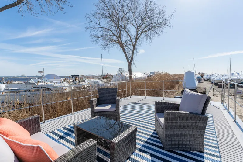 Slide: The Image of Waterlodge Apart EL 2024 model with outdoor seating on a marina deck. - 26