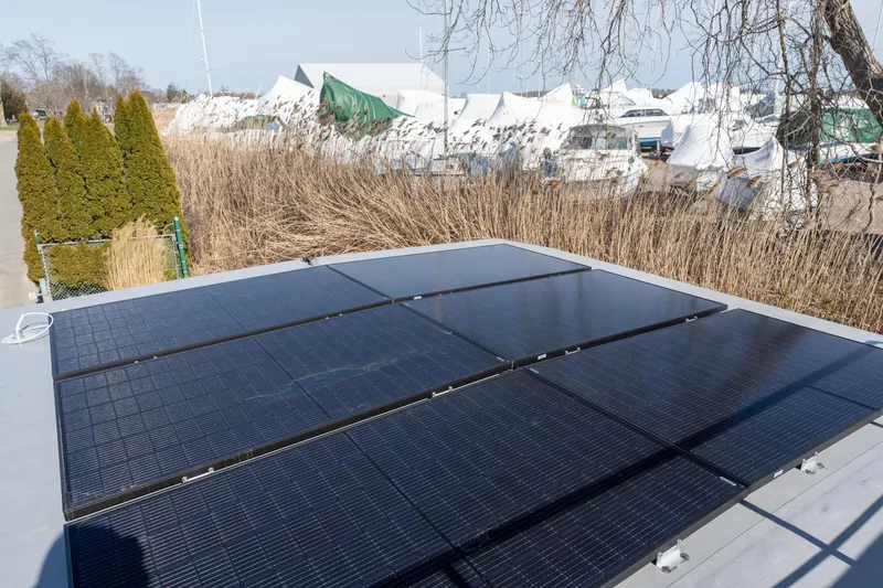 Slide: The Image of Solar panels on the roof of a 2024 Waterlodge Apart EL houseboat. - 27