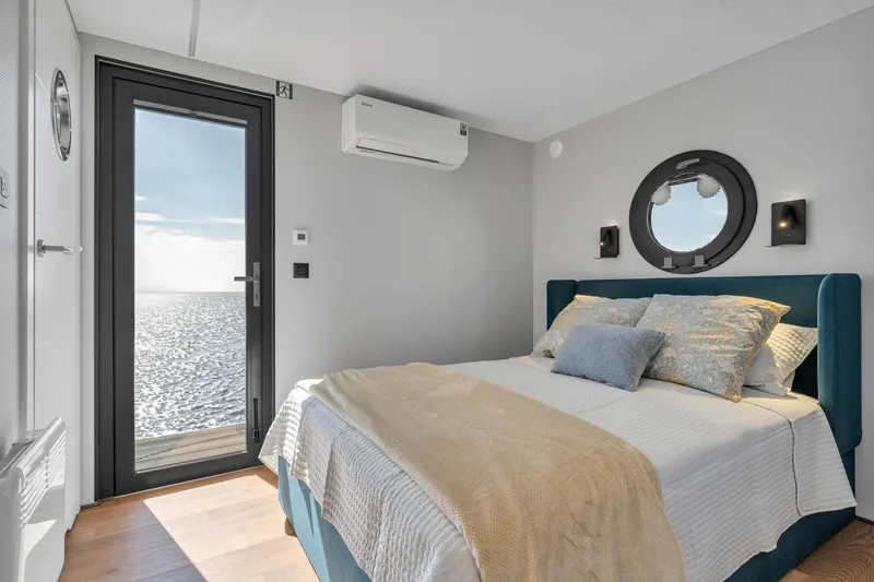 Slide: The Image of Modern bedroom in Waterlodge Apart EL 2024 with ocean view, cozy bed, and stylish decor. - 3