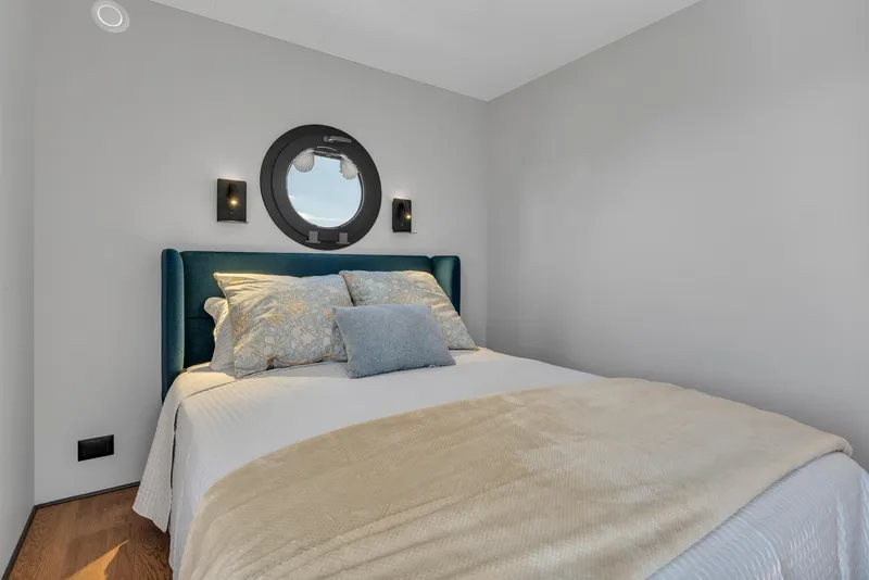 Slide: The Image of Cozy bedroom in 2024 Waterlodge Apart EL with porthole window and modern decor. - 4