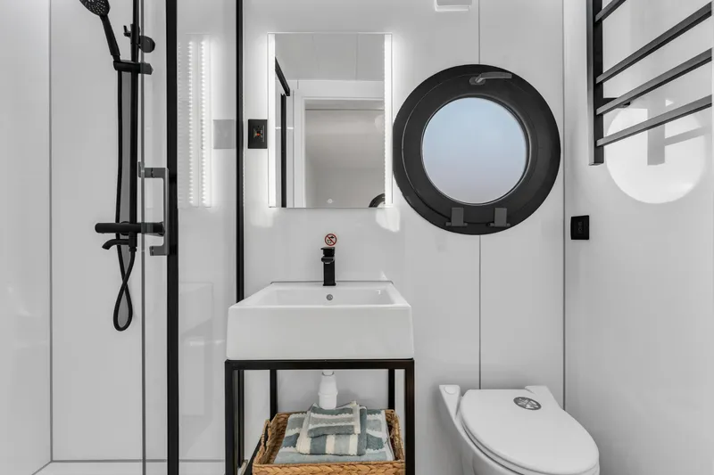 Slide: The Image of Modern bathroom in 2024 Waterlodge Apart EL with shower, sink, and toilet. - 7