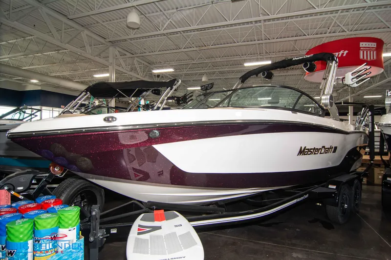 Slide: The Image of 2024 MasterCraft XT24 boat displayed indoors. - 0