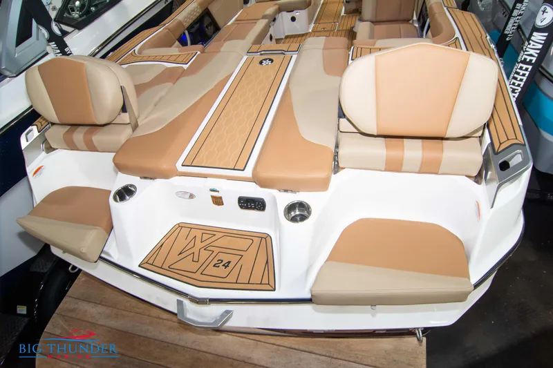 Slide: The Image of 2024 MasterCraft XT24 boat with tan and white seating and deck. - 10
