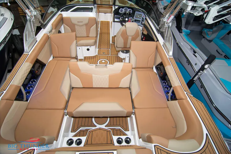 Slide: The Image of 2024 MasterCraft XT24 boat interior with tan and beige seating. - 14