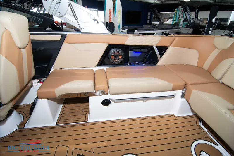 Slide: The Image of 2024 MasterCraft XT24 boat interior with tan leather seating and teak flooring. - 16