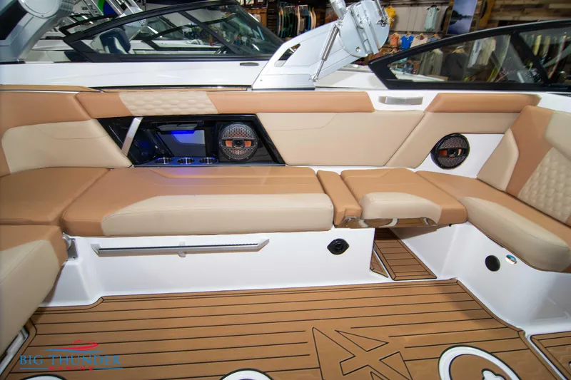 Slide: The Image of 2024 MasterCraft XT24 boat interior with tan leather seating and teak flooring. - 18