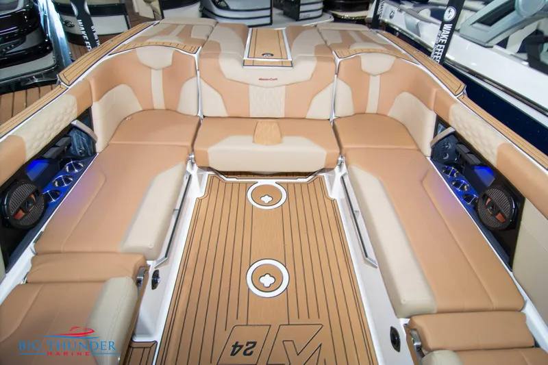Slide: The Image of 2024 MasterCraft XT24 boat interior with tan and beige seating. - 20
