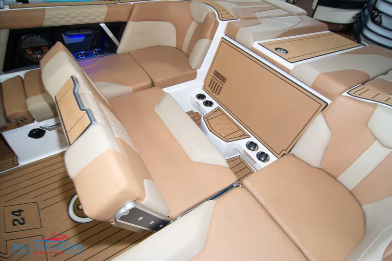 Slide: The Image of 2024 MasterCraft XT24 boat interior with tan and beige seating. - 22