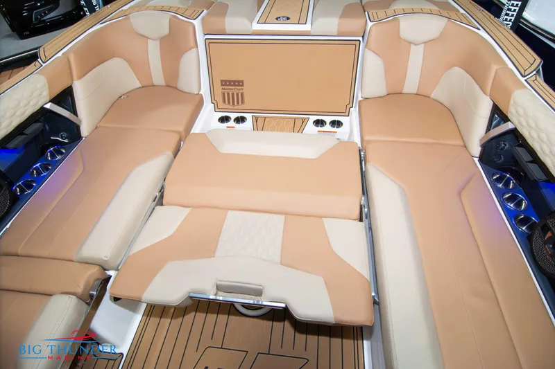 Slide: The Image of 2024 MasterCraft XT24 boat interior with tan and beige seating. - 23