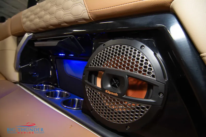 Slide: The Image of 2024 MasterCraft XT24 boat interior with Klipsch speaker and cup holders. - 24