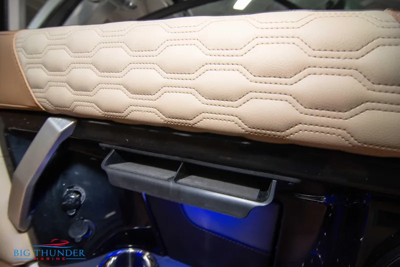 Slide: The Image of 2024 MasterCraft XT24 boat interior with beige hexagonal-stitched upholstery. - 25