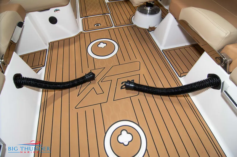 Slide: The Image of 2024 MasterCraft XT24 boat interior with teak flooring and logo. - 27