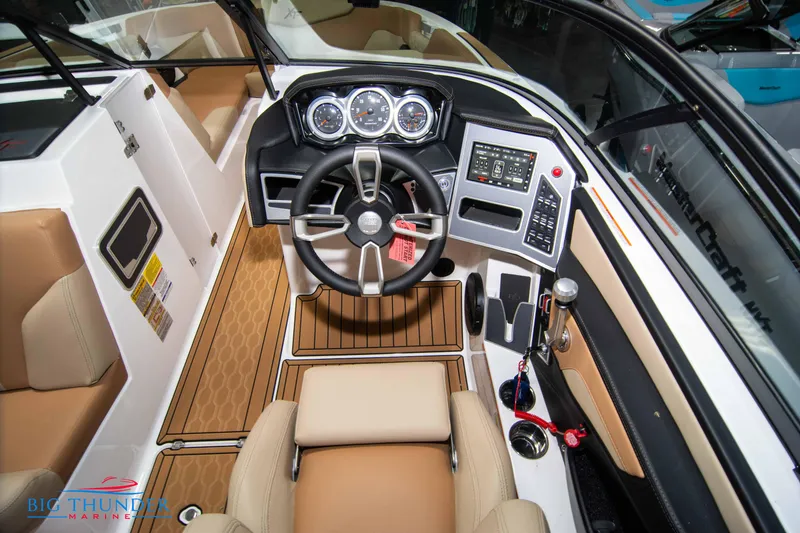 Slide: The Image of 2024 MasterCraft XT24 boat cockpit with modern controls and tan seating. - 28