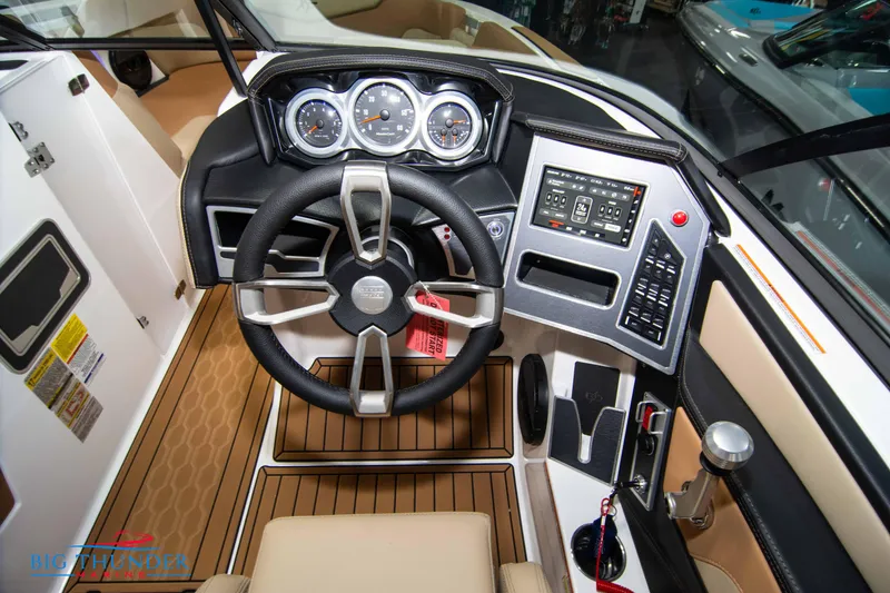 Slide: The Image of 2024 MasterCraft XT24 boat cockpit with modern steering wheel and control panel. - 29