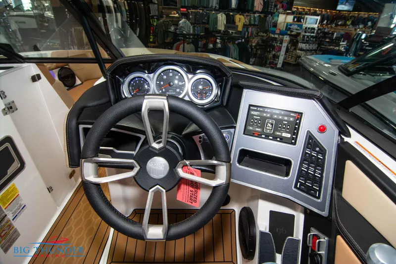 Slide: The Image of 2024 MasterCraft XT24 boat dashboard with steering wheel, gauges, and control panel. - 30