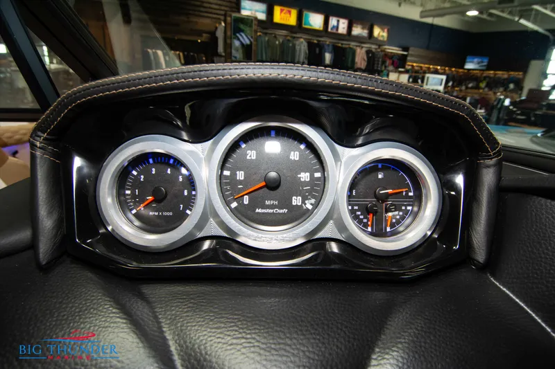 Slide: The Image of 2024 MasterCraft XT24 boat dashboard with speedometer and gauges. - 31