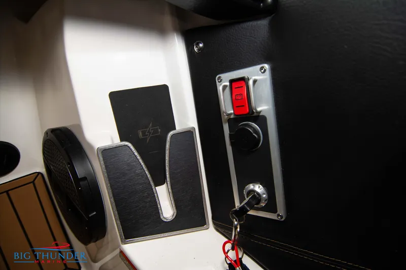 Slide: The Image of Control panel of 2024 MasterCraft XT24 boat with ignition switch and red button. - 33