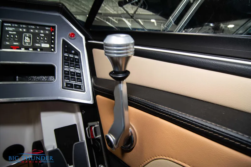 Slide: The Image of 2024 MasterCraft XT24 boat control panel and throttle lever. - 34