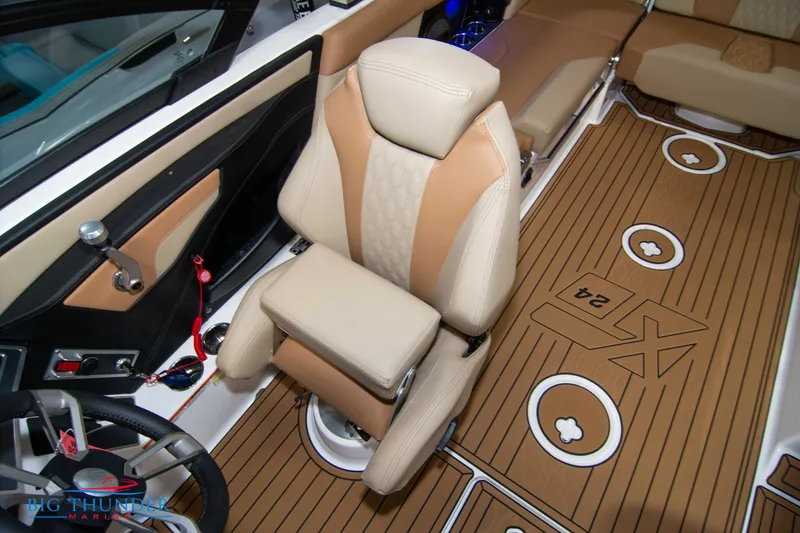 Slide: The Image of 2024 MasterCraft XT24 boat interior with tan and beige seating and teak flooring. - 38