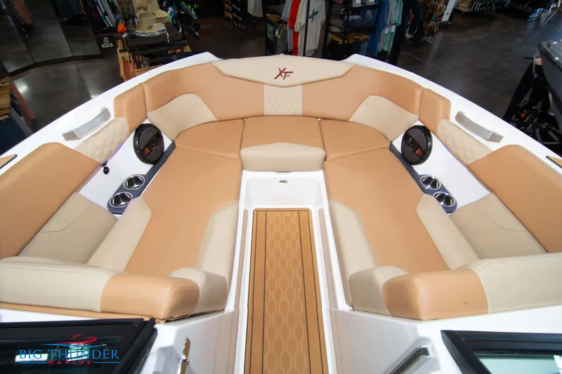 Slide: The Image of 2024 MasterCraft XT24 boat interior with tan and beige seating. - 41