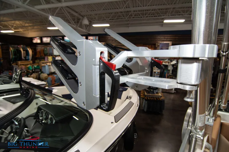 Slide: The Image of 2024 MasterCraft XT24 boat in showroom with wakeboard rack. - 46