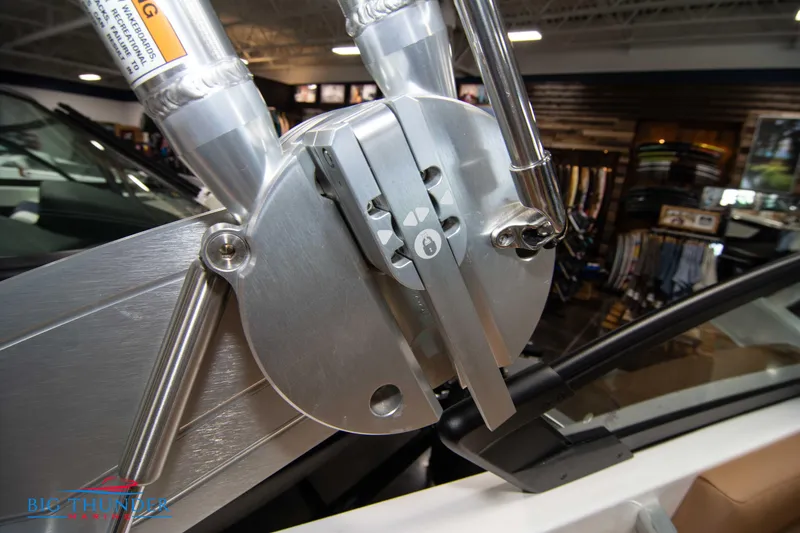 Slide: The Image of Close-up of 2024 MasterCraft XT24 boat's polished metal component in showroom. - 47