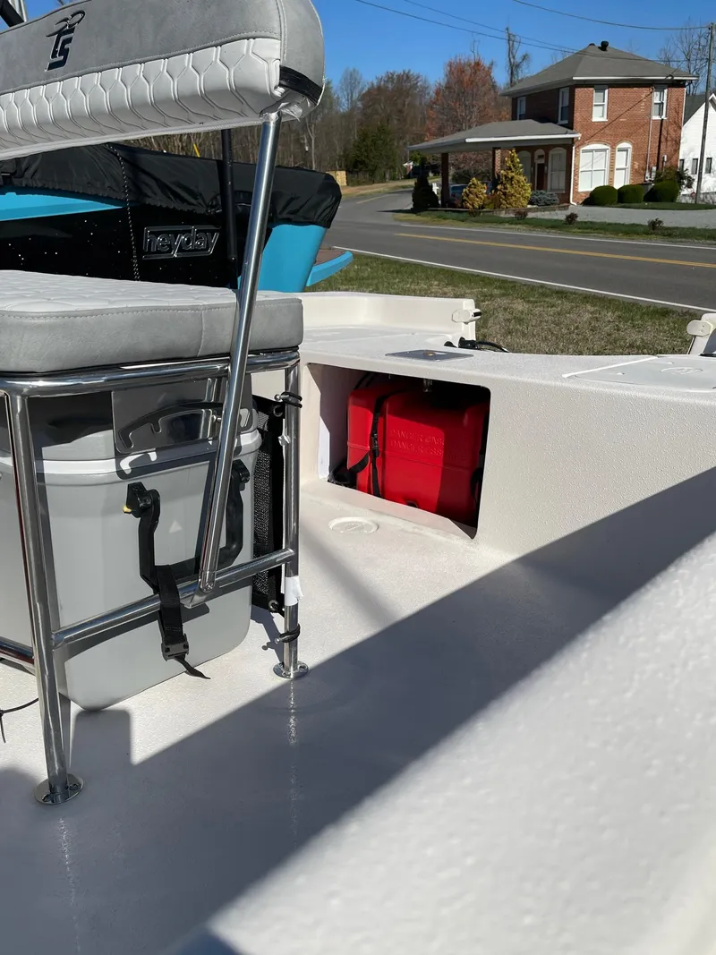 Slide: The Image of 2024 Carolina Skiff EV 198 boat interior with seating and storage compartments. - 6