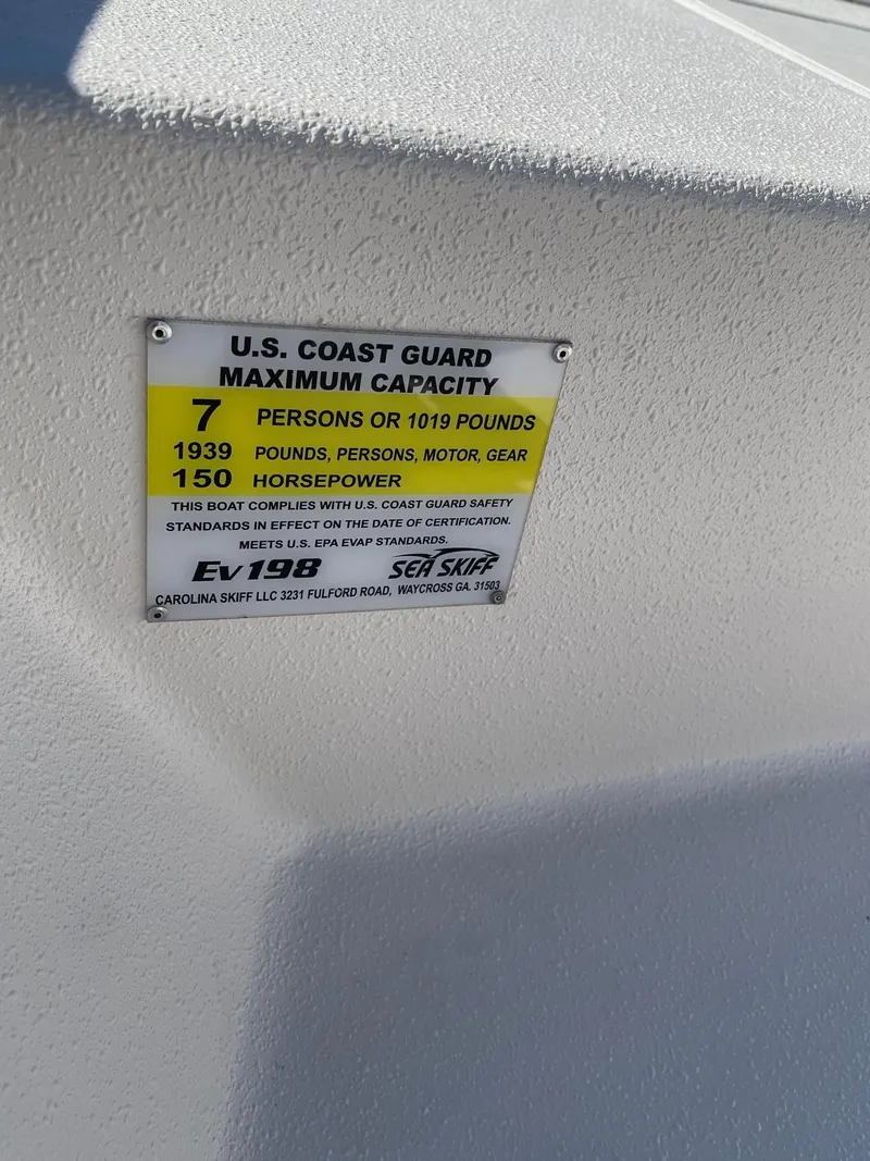 Slide: The Image of 2024 Carolina Skiff EV 198 capacity label, 7 persons or 1019 pounds, 150 horsepower. - 8