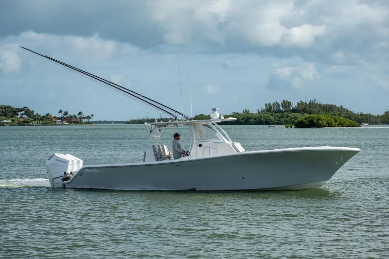 The Image of 2021 Front Runner 36 Center Console boat cruising on a calm waterway. - 0