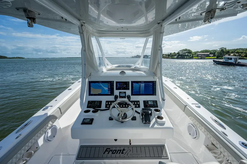 Slide: The Image of 2021 Front Runner 36 Center Console boat dashboard with navigation screens on open water. - 10