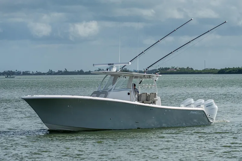 Slide: The Image of 2021 Front Runner 36 Center Console boat on calm waters with fishing rods. - 21