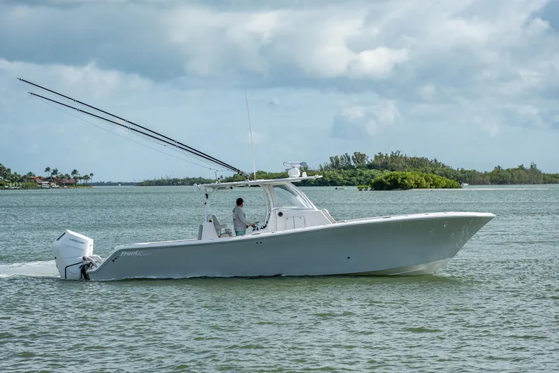 Slide: The Image of 2021 Front Runner 36 Center Console boat cruising on a calm lake. - 23