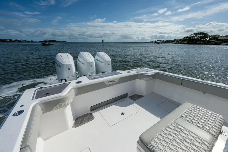 Slide: The Image of 2021 Front Runner 36 Center Console boat with triple outboard engines on the water. - 9