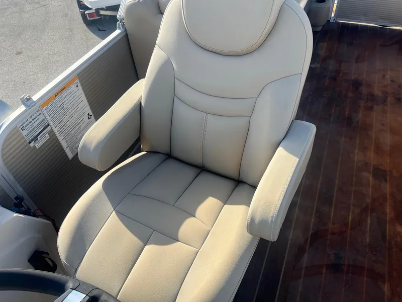 Slide: The Image of 2019 Godfrey Sweetwater 2286 boat seat with beige upholstery and armrests. - 13
