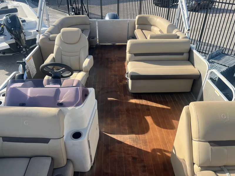 Slide: The Image of 2019 Godfrey Sweetwater 2286 pontoon boat interior with beige seating and wood flooring. - 14