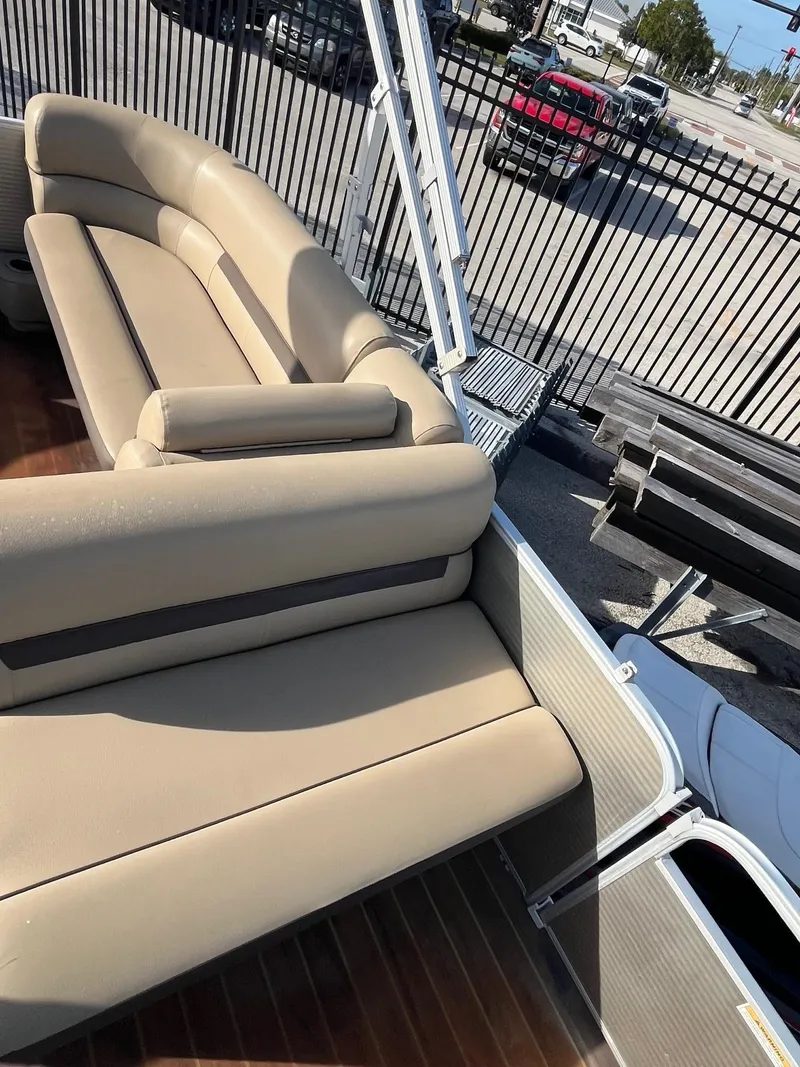 Slide: The Image of 2019 Godfrey Sweetwater 2286 pontoon boat with beige seating and metal railings. - 15