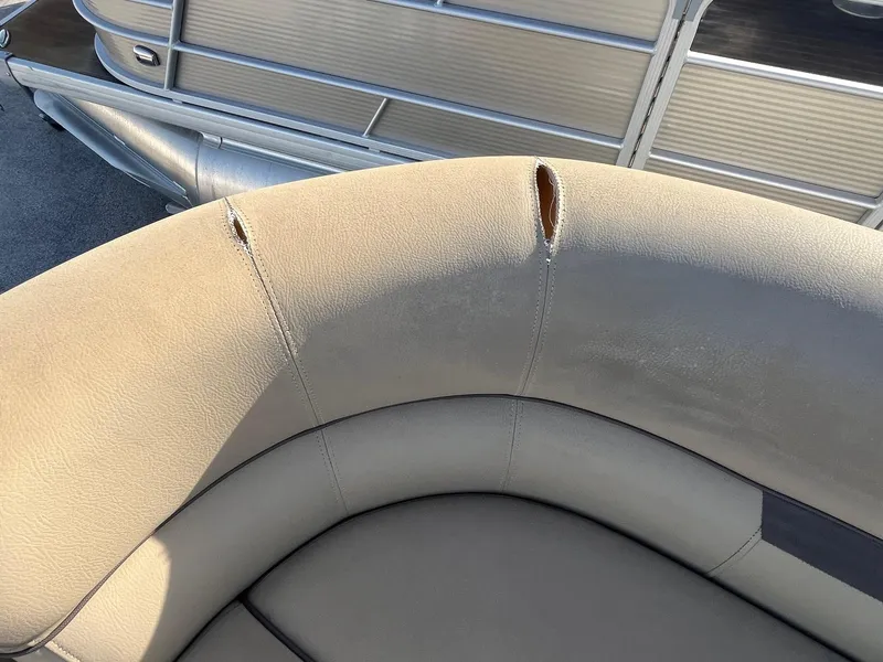 Slide: The Image of Torn upholstery on 2019 Godfrey Sweetwater 2286 boat seat, showing wear and damage. - 4