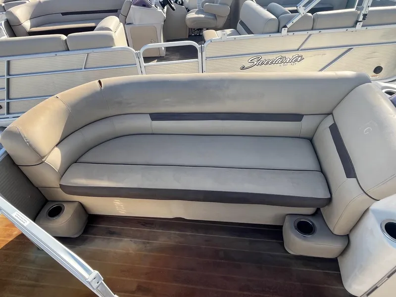 Slide: The Image of 2019 Godfrey Sweetwater 2286 boat seating with cup holders and cushioned bench. - 5