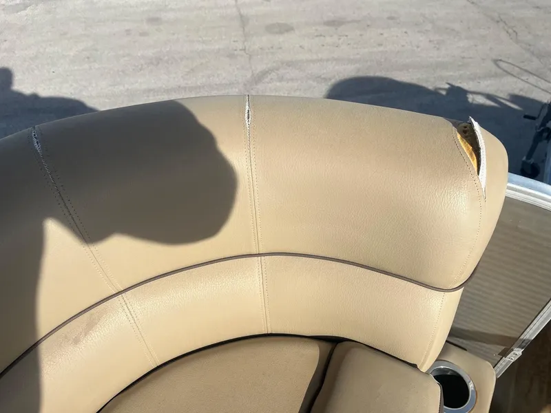 Slide: The Image of Torn beige upholstery on 2019 Godfrey Sweetwater 2286 boat seat. - 6