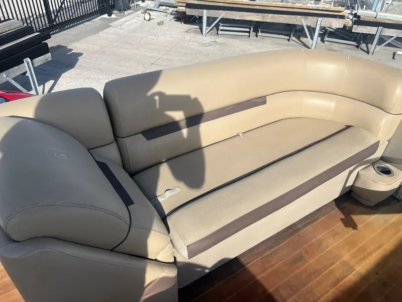 Slide: The Image of 2019 Godfrey Sweetwater 2286 boat seating with beige upholstery and cup holder. - 8