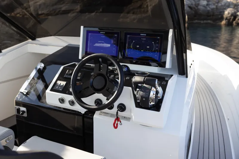 Slide: The Image of 2025 De Antonio Yachts D36 OPEN helm with modern controls and dual navigation screens. - 5