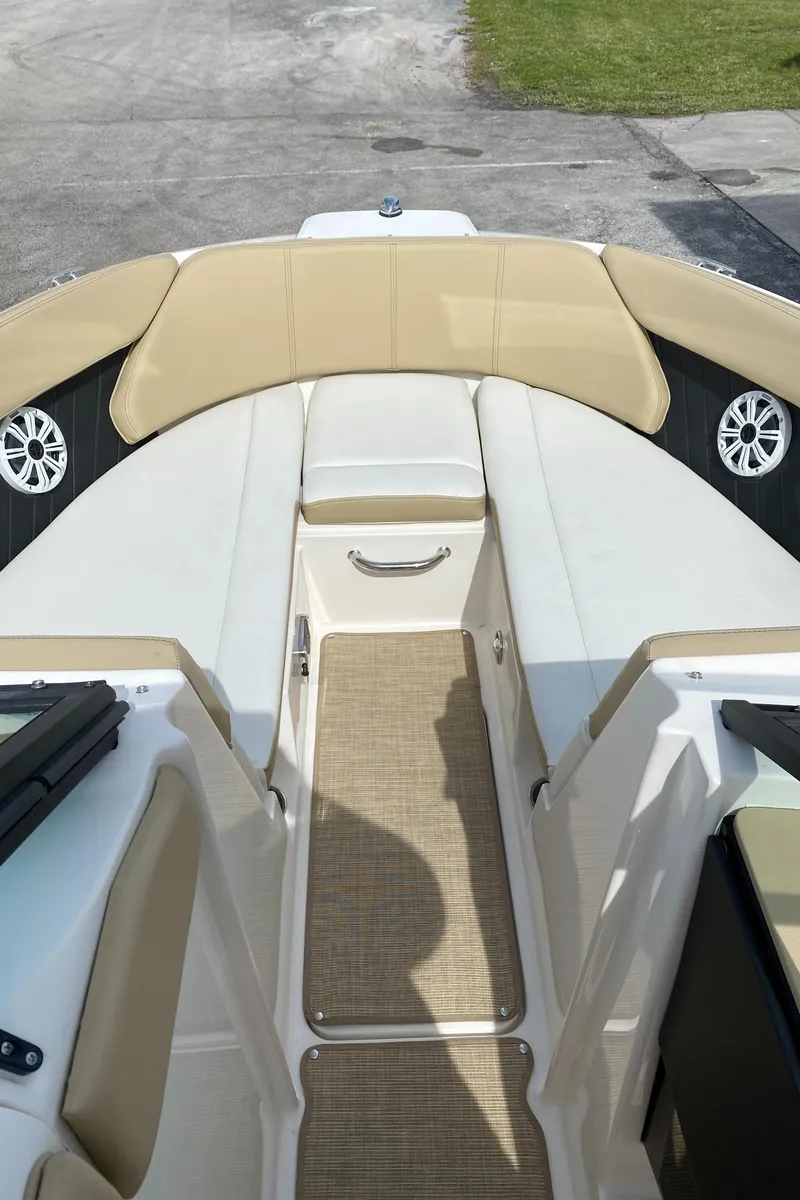 Slide: The Image of 2018 Sea Ray SLX 230 boat interior with beige and white seating. - 10