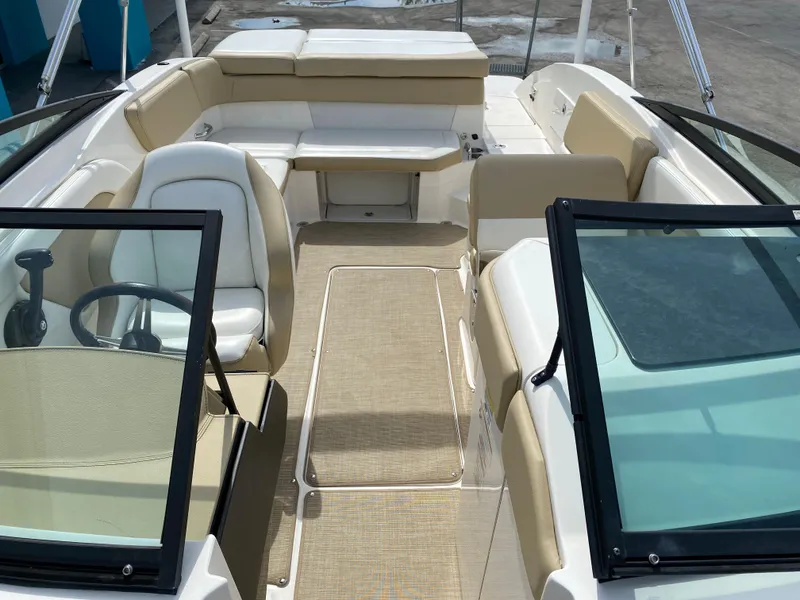Slide: The Image of 2018 Sea Ray SLX 230 boat interior with beige and white seating. - 3