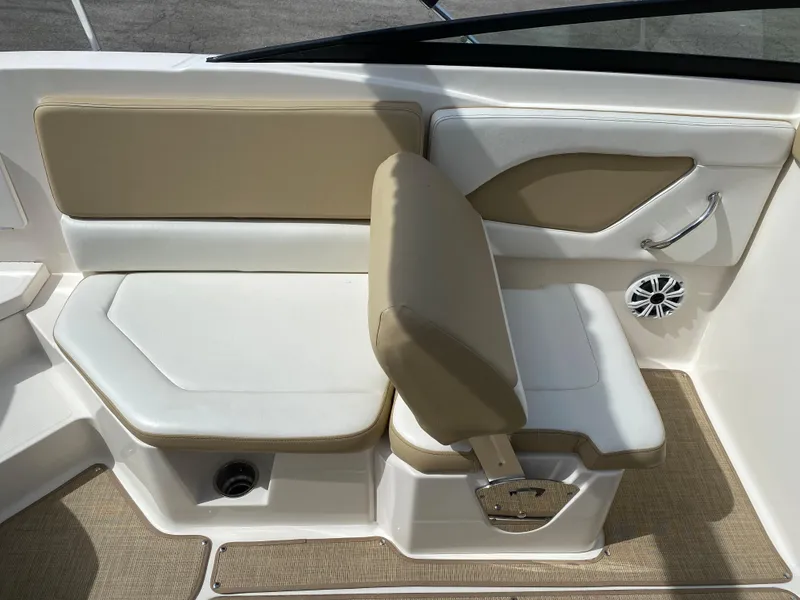Slide: The Image of 2018 Sea Ray SLX 230 boat interior seating with beige and white upholstery. - 4