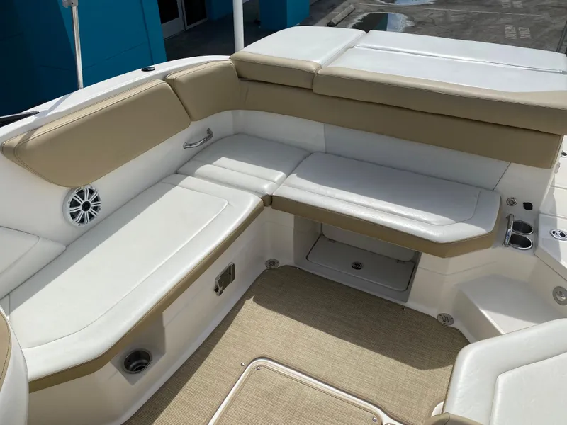 Slide: The Image of 2018 Sea Ray SLX 230 boat interior with beige and white seating. - 5