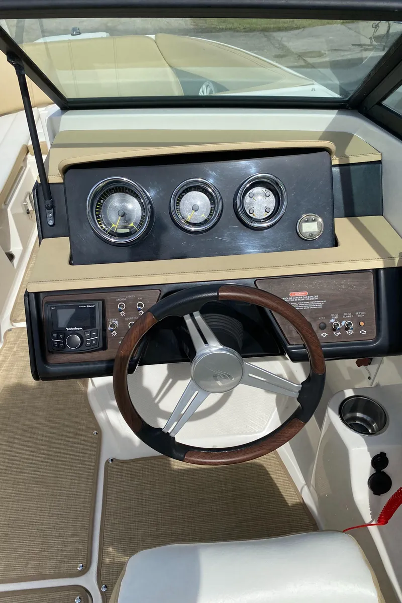 Slide: The Image of 2018 Sea Ray SLX 230 boat dashboard with steering wheel and gauges. - 6