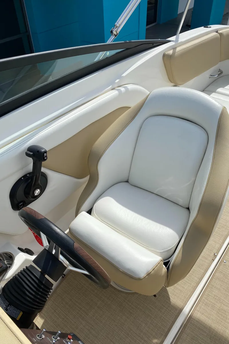Slide: The Image of 2018 Sea Ray SLX 230 boat interior, captain's seat and controls. - 7