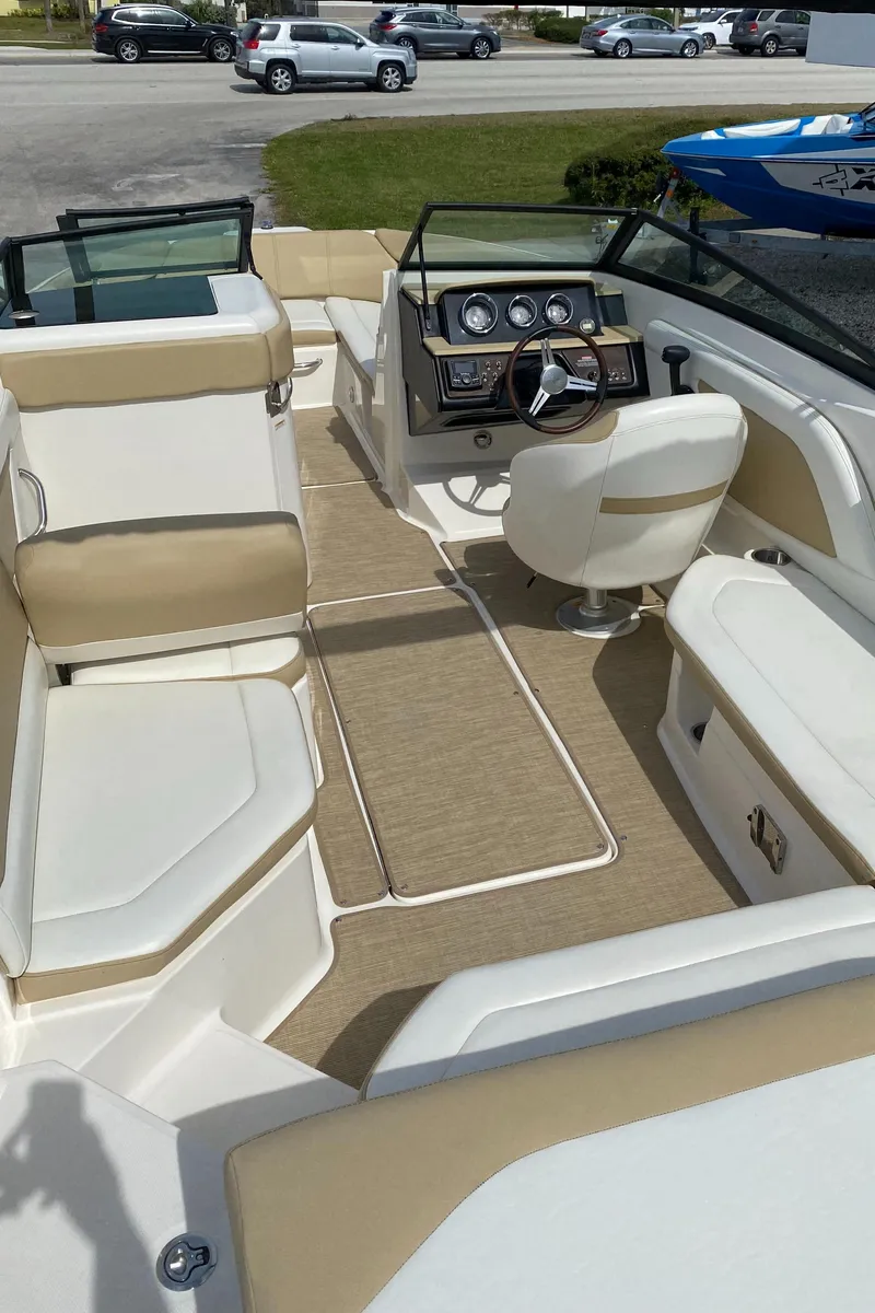 Slide: The Image of 2018 Sea Ray SLX 230 boat interior with beige and white seating. - 8