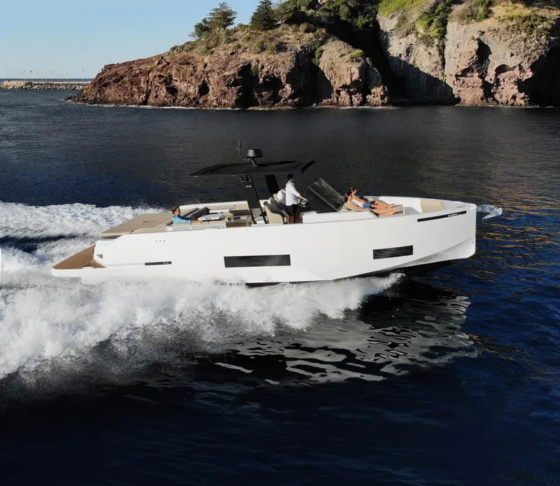 Slide: The Image of 2024 De Antonio Yachts D42 Open cruising near rocky coastline. - 10